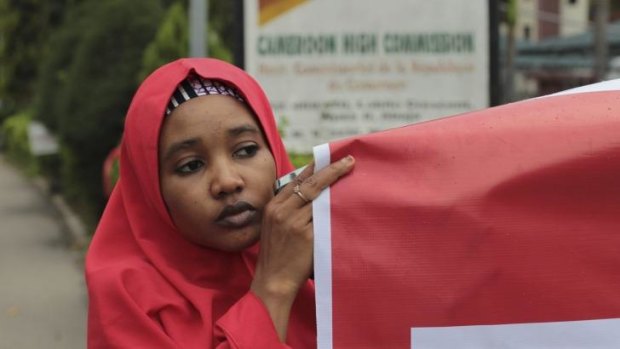 A young girl joins people demonstrating on October 14, 2014, for the Nigerian Government to rescue 217 schoolgirls kidnapped by Boko Haram rebels.