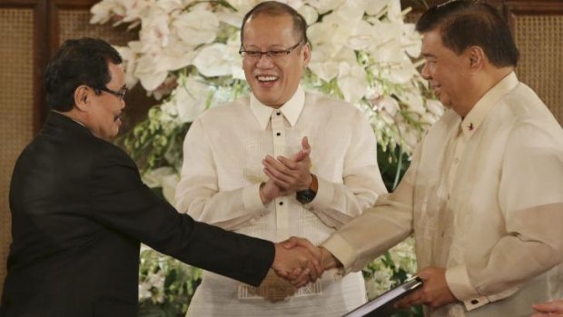 Philippine President Benigno Aquino (centre), with Moro Islamic Liberation Front chief negotiator Mohagher Iqbal (left) and Senate President Franklin Drilon.