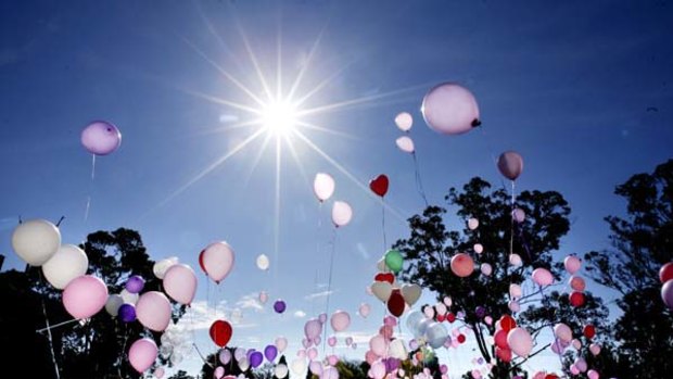 Vigil ...  balloons are released near Kiesha’s home.