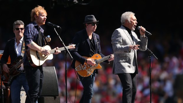 Tom Jones and Ed Sheeran perform at the 2014 AFL Grand Final, Jones is set to return as a solo act for Bluesfest.