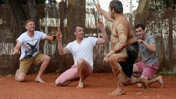 England cricketers Graeme Swann and Jonathan Bairstowperform with Wakagetti cultural dancers at Uluru.