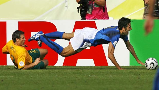 Justice: Australia's Lucas Neill tackles Italy's Fabio Grosso.