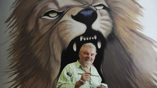 Art and craft ... Roger Robinson in front of his mural at a Drummoyne cafe.