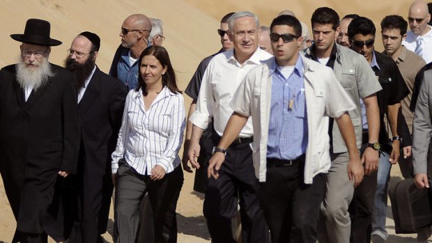 Looming poll ... Benjamin Netanyahu, centre, visits Ashdod, near the Gaza border, last week.