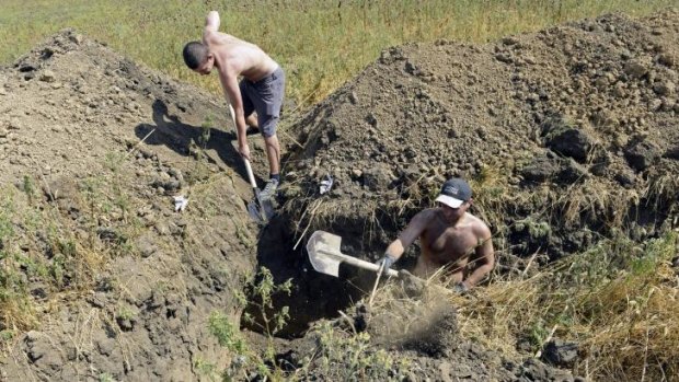 Residents of Mariupol dig trenches as they assist Ukrainian troops in organising their defence on the outskirts of the southern Ukrainian city.
