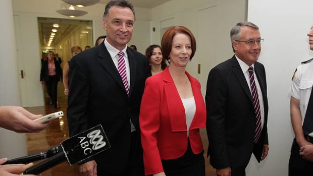 Julia Gillard flanked by Craig Emerson and Wayne Swan.