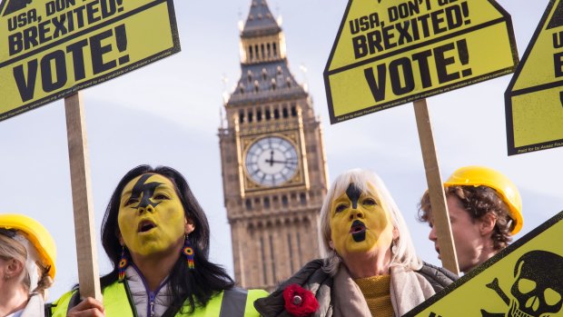 Demonstrators, organised by the civic movement AVAAZ in London, hold placards calling on Americans to vote and avoid getting 'Brexited'.
