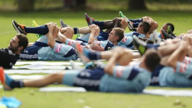At a stretch: Frank Farina's troops are put through their paces on Tuesday ahead of Friday's elimination final against arch rivals Melbourne Victory.