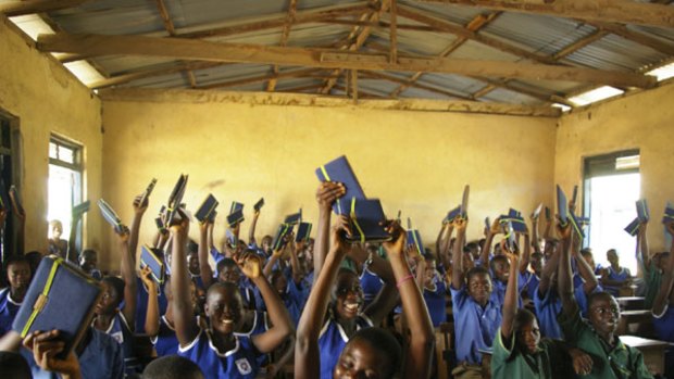 Students show off some of the 500 Kindles sent to Ghana by Worldreader.org.