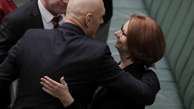 Prime Minister Julia Gillard and Education Minister Peter Garrett embrace after the passing of the Australian Education Bill earlier this month.