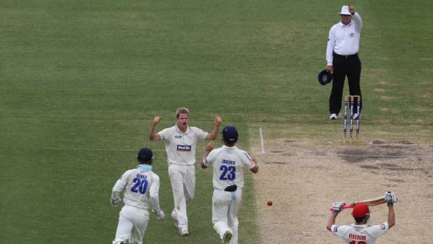 Gone ... Steve Smith celebrates the wicket of Callum Ferguson in yesterday's Sheffield Shield clash between NSW and South Australia.