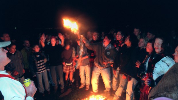 Fans light a fire on the oval when the lights went out in a night football match: Essendon v St Kilda: AFL Park Waverley