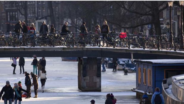 Snap to it &#8230; people skate on the Keizersgracht canal in Amsterdam. Cold weather means the Dutch might be able to hold a race on frozen canals for the first time in 15 years.
