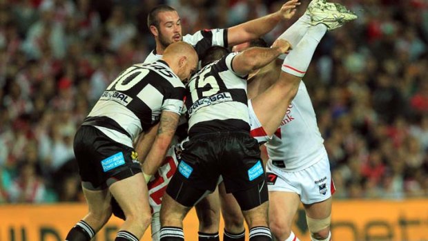 Upended ... Trent Merrin is seized upon by Aaron Wood, Keith Galloway and Todd Payten.