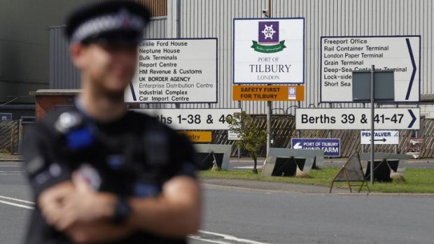 A policeman stands guard outside the entrance to London's Tilbury Docks after a group of stowaways was found inside a shipping container.