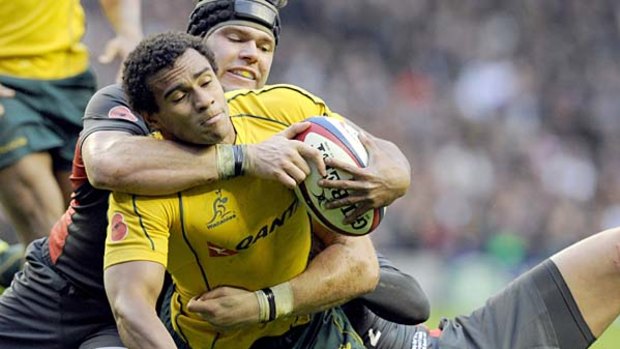 Turning point . . . Will Genia is tackled just short of the England line, but the subsequent turnover saw the hosts streak away for a length-of-the field try.