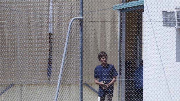 Uncertain future ... one of a group of teenage asylum seekers bides his time at the Phosphate Hill detention centre.