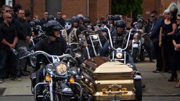TBuried in a golden casket ... the funeral for Lone Wolf bikie Neal Todorowski took place on Saturday.