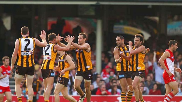 On song: Hawthorn players celebrate a goal on the way to their win over Sydney yesterday.