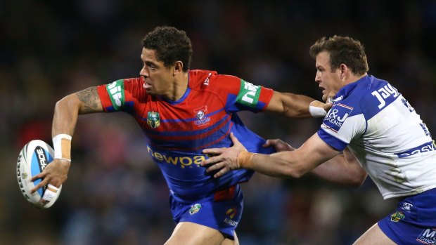 Dane Gagai of the Knights gets his pass away from Josh Morris of the Bulldogs during last year's round 25 fixture against the Bulldogs.