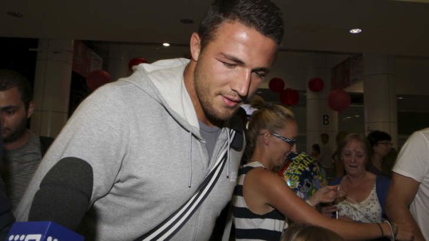 No comment: Sam Burgess hurries through the terminal.