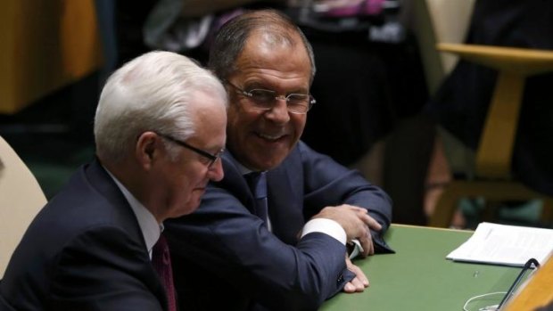 Russia's Foreign Minister Sergey Lavrov (right) smiles as he talks with Russia's Ambassador to the United Nations Vitaly Churkin during Barack Obama's speech.