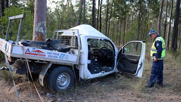 Forensic Crash investigator Sergeant Steve Webb inspects the wreck of the Nissan Navara ute. Photo: <B><A href= http://www.gympietimes.com.au/news/one-dead-after-car-hits-tree-north-theebine/1613270/ > Craig Warhurst - The Gympie Times </a></b>
