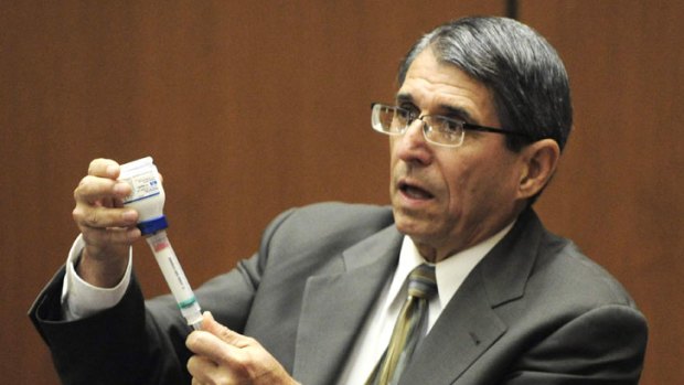 Dr. Paul White, an anaesthesiologist and propofol expert, demonstrates how propofol is loaded into a syringe at the trial of Doctor Conrad Murray.