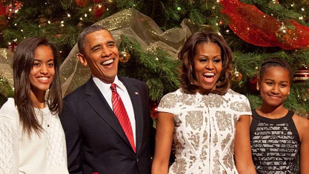 First family: Barack and Michelle Obama, with their daughters Malia (left) and Sasha at Christmas.
