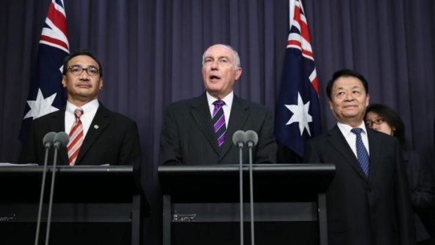 Malaysian Acting Transport Minister, Hishammuddin Husssein, Deputy Prime Minister Warren Truss and Chinese Transport Minister, Yang Chuantan address the media after their meeting on the search for MH370 at Parliament House in Canberra.