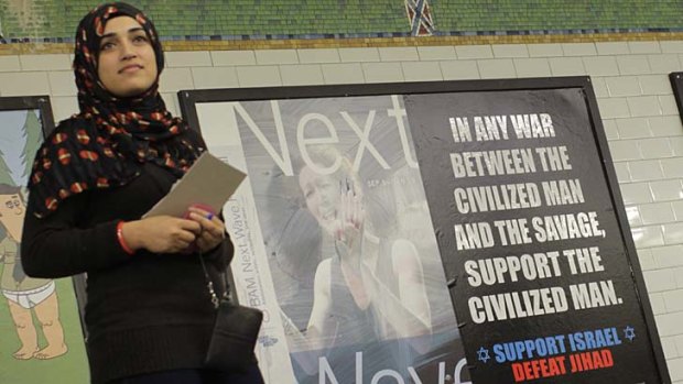 Spreading the news ... Muslim-American Javeraea Khan hands out pamphlets challenging the ''Support Israel, Defeat Jihad'' ad posted at Times Square station.