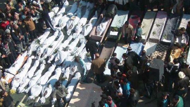 Bloodiest day ... mourners gather around the coffins of those killed in government attacks in the Khaldiyeh neighbourhood in Homs province, central Syria, on Saturday.