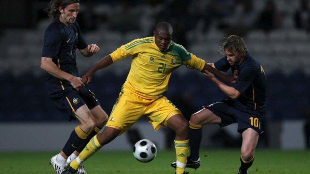 Here we go again: Socceroos pair Josh Kennedy (left) and Brett Holman challenge South Africa's Kagisho Dikgacoi at Craven Cottage in 2008 - the most recent clash between the countries.
