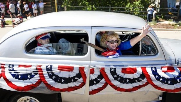 Gun rights: Joanne Canda, right, waves to parade goers during a demonstration for the Independence Day parade in Westcliffe, Colorado.