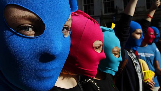 World is watching ... masked protesters take part in a flash mob demonstration in Edinburgh, Scotland, in support of the Russian punk group Pussy Riot.