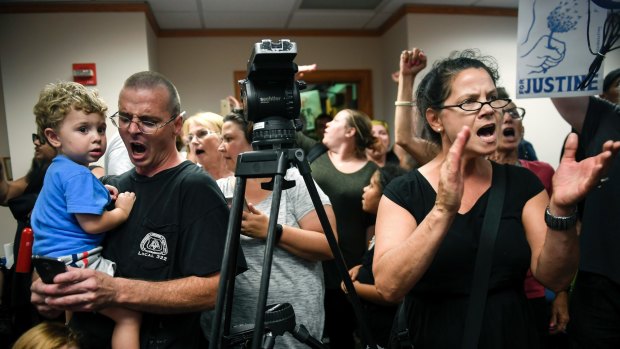 Protesters chant slogans against Minneapolis mayor Betsy Hodges during her press conference.