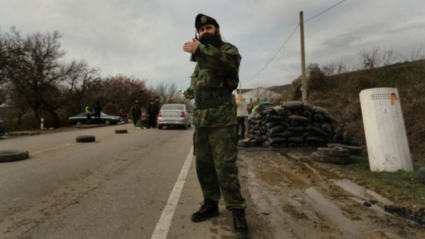 Serbian Chetnik militia leader Bratislav Zivkovic, who is in Crimea supporting the Russians, at a checkpoint heading towards Sevastopol from Simferopol, checking vehicles for weapons.