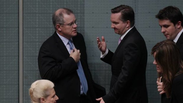 Shadow Immigration Minister Scott Morrison speaks with Immigration Minister Chris Bowen at the end of Question Time at Parliament House yesterday.