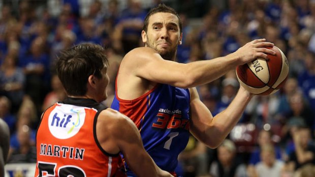 Adelaide guard Adam Gibson is defended by Perth's Damian Martin during game two of the NBL Grand Final series at Adelaide Entertainment Centre.