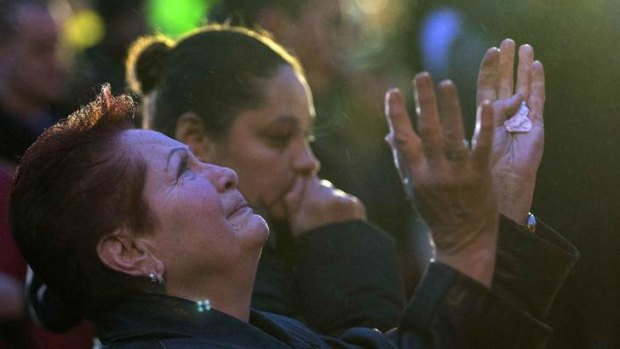 Unfathomable ... a woman grieves after visiting a memorial for the victims in Newtown.