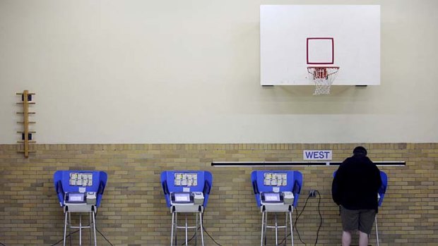 Every vote counts ... a man casts his ballot using an electronic voting machine at an elementary school in Bowling Green, Ohio.