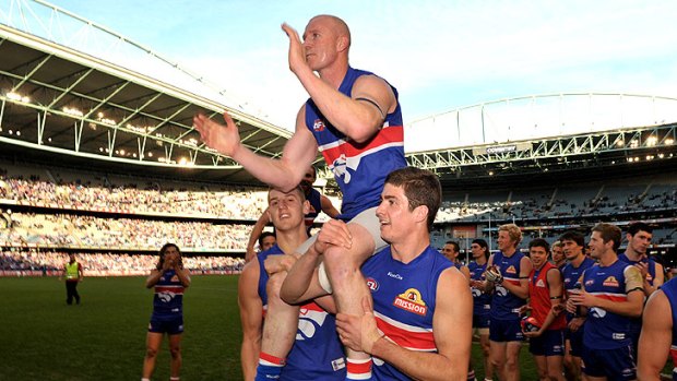 Barry Hall is chaired off the ground after his final game.