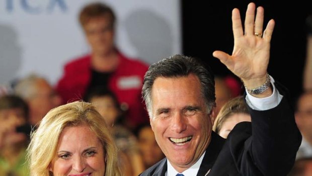 Republican presidential hopeful Mitt Romney and wife Ann celebrate during a primary election night event.