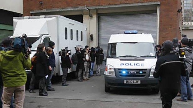 Members of the media gather outside the rear entrance of Westminster Magistrates Court in London.
