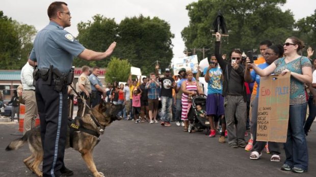 Protestors confront police during an impromptu rally, Sunday, in Ferguson, Missouri.