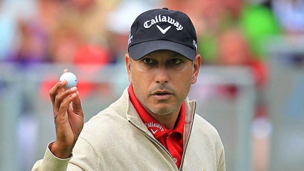Jeev Milkha Singh acknowledges the crowd after finishing 8 under par on the 18th green during the first round of the Irish Open.