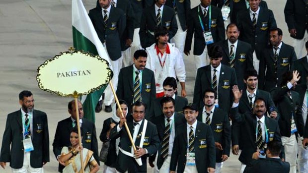 Delegation Chef de mission Mohammad Ali Shah carries the Pakistan flag at the Opening Ceremony.