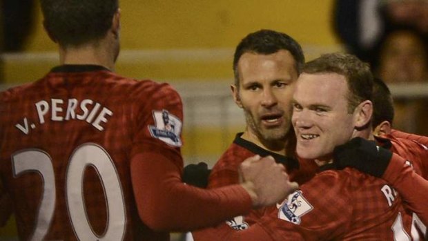 Manchester United's Wayne Rooney (right) is congratulated by team mate Ryan Giggs.