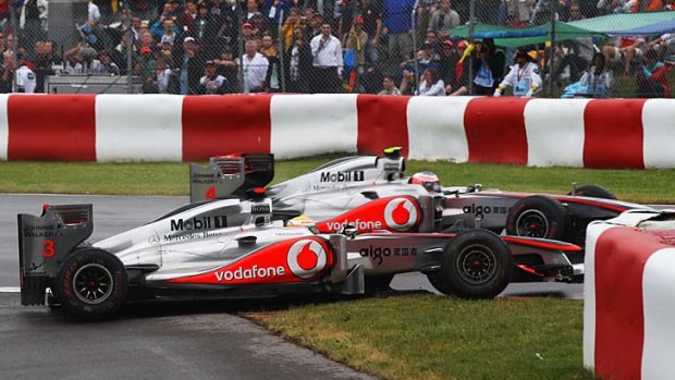 Controversial ... Lewis Hamilton, front, drives close to teammate Jenson Button bvefore crashing into him.