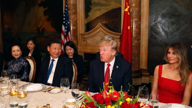 President Donald Trump and Chinese President Xi Jinping, with their wives, first lady Melania Trump and Chinese first lady Peng Liyuan are seated during a dinner at Mar-a-Lago.